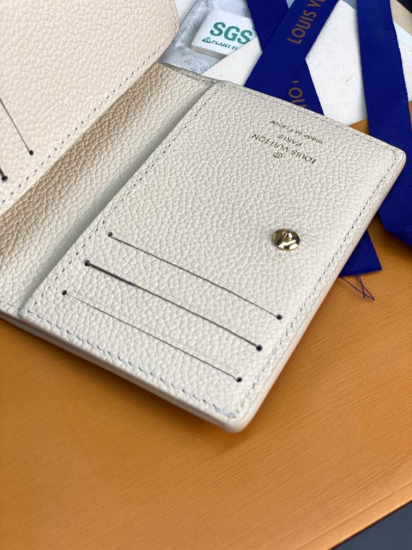 The M80151 milky white silk printed Cla wallet is made of Monogram Imprente soft grain cow