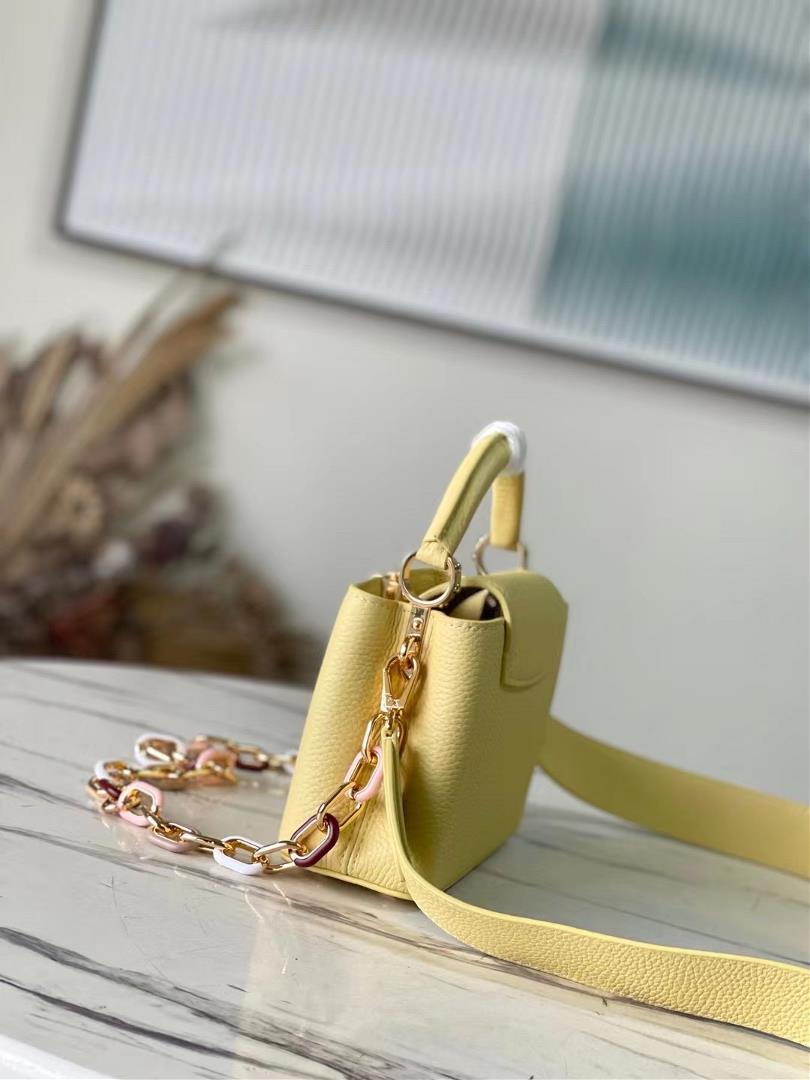 The toplevel original M21798 yellow mini Capuchines mini handbag features metal and resin link