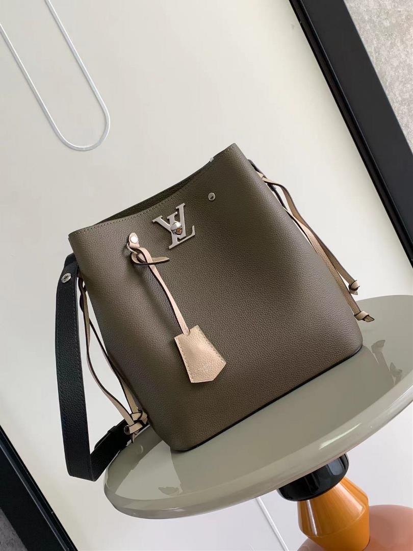 M54677s latest water bucket bag features imported soft calf leather with a shiny twist lock closure