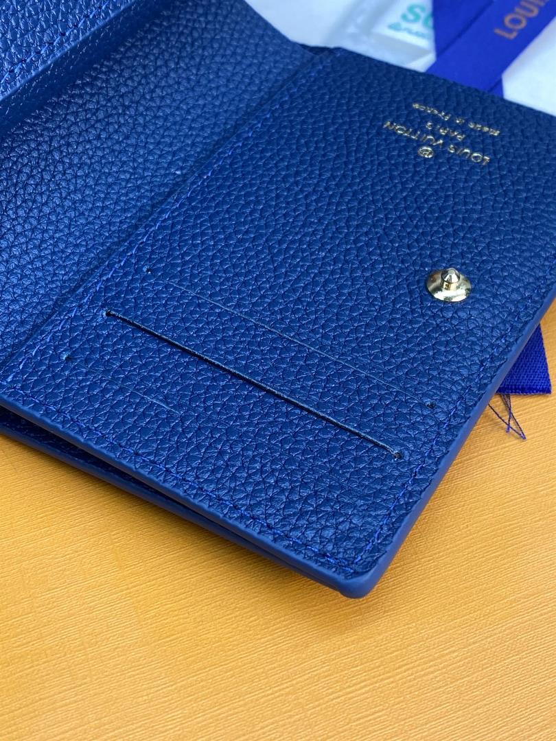 The M82329 blue screen printed Cla wallet is made of Monogram Imprente soft grain cowhide