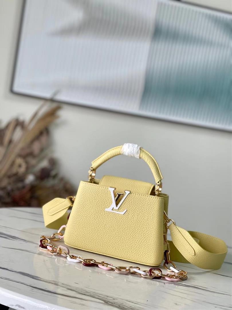 The toplevel original M21798 yellow mini Capuchines mini handbag features metal and resin links that