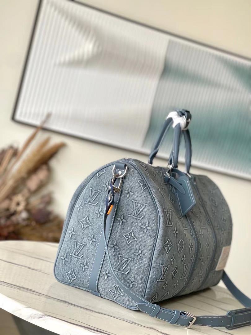 M22532 denim This Keepall Bandoulire 50 travel bag is embossed with Monogram pattern on fa