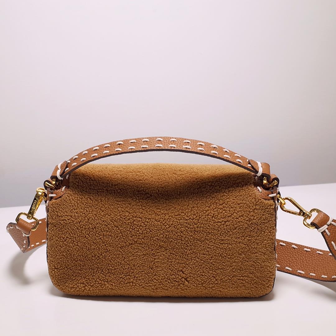 FEND1 signature medium Baguette handbag made of soft brown merino sheepskin with oversized han