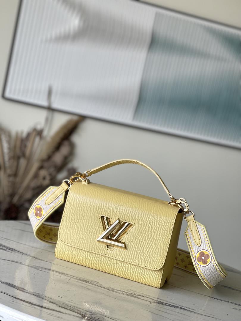 M22036 yellowThis Twist medium size handbag is paired with embroidered fabric shoulder straps dividi