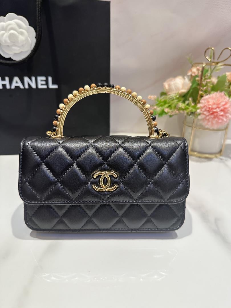 The Chanel 23A Wooden Bead Handle Mobile Phone Bag Handicraft Workshop series features exq