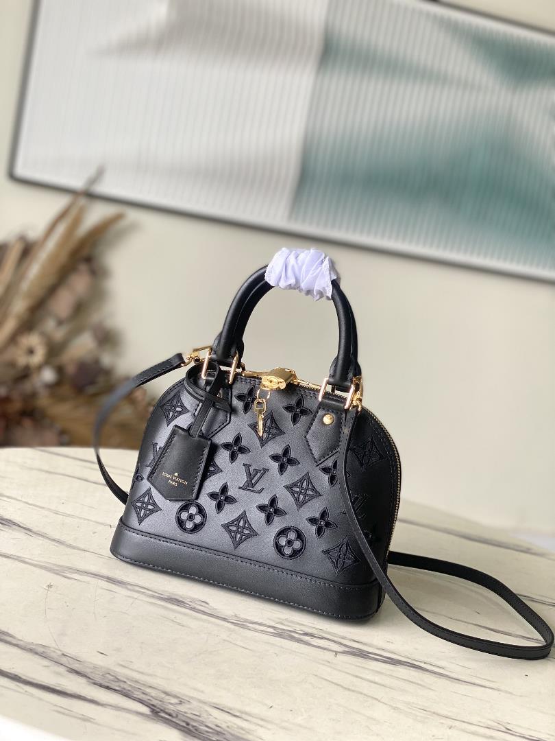 M22878 black 91606 perforated blackThis Alma BB handbag originates from the LV Broderie Anglaise col