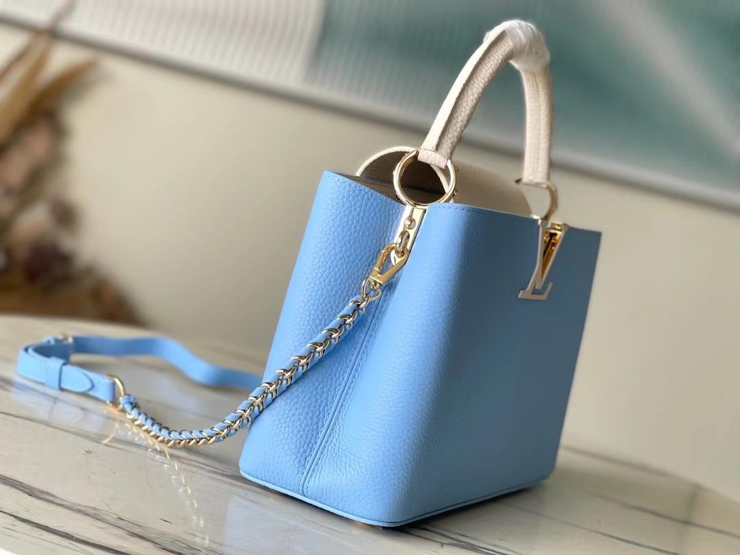 M21887 blue medium size Taurilon leather version of the Capuchines handbag presents a soft