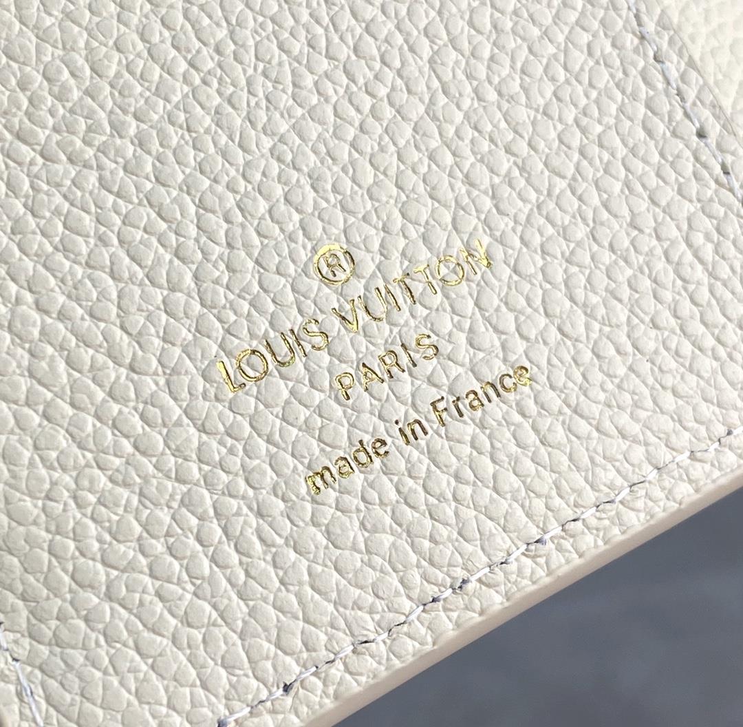 The M80151 milky white silk printed Cla wallet is made of Monogram Imprente soft grain cow