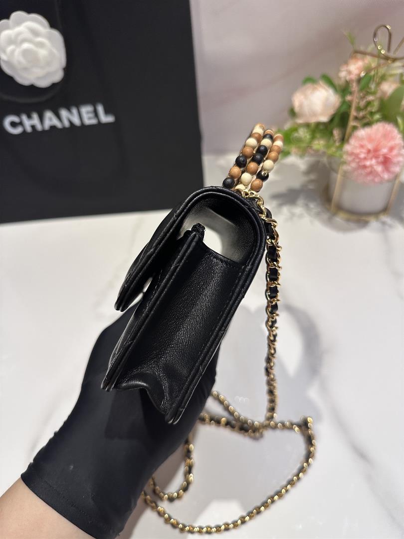 The Chanel 23A Wooden Bead Handle Mobile Phone Bag Handicraft Workshop series features exq