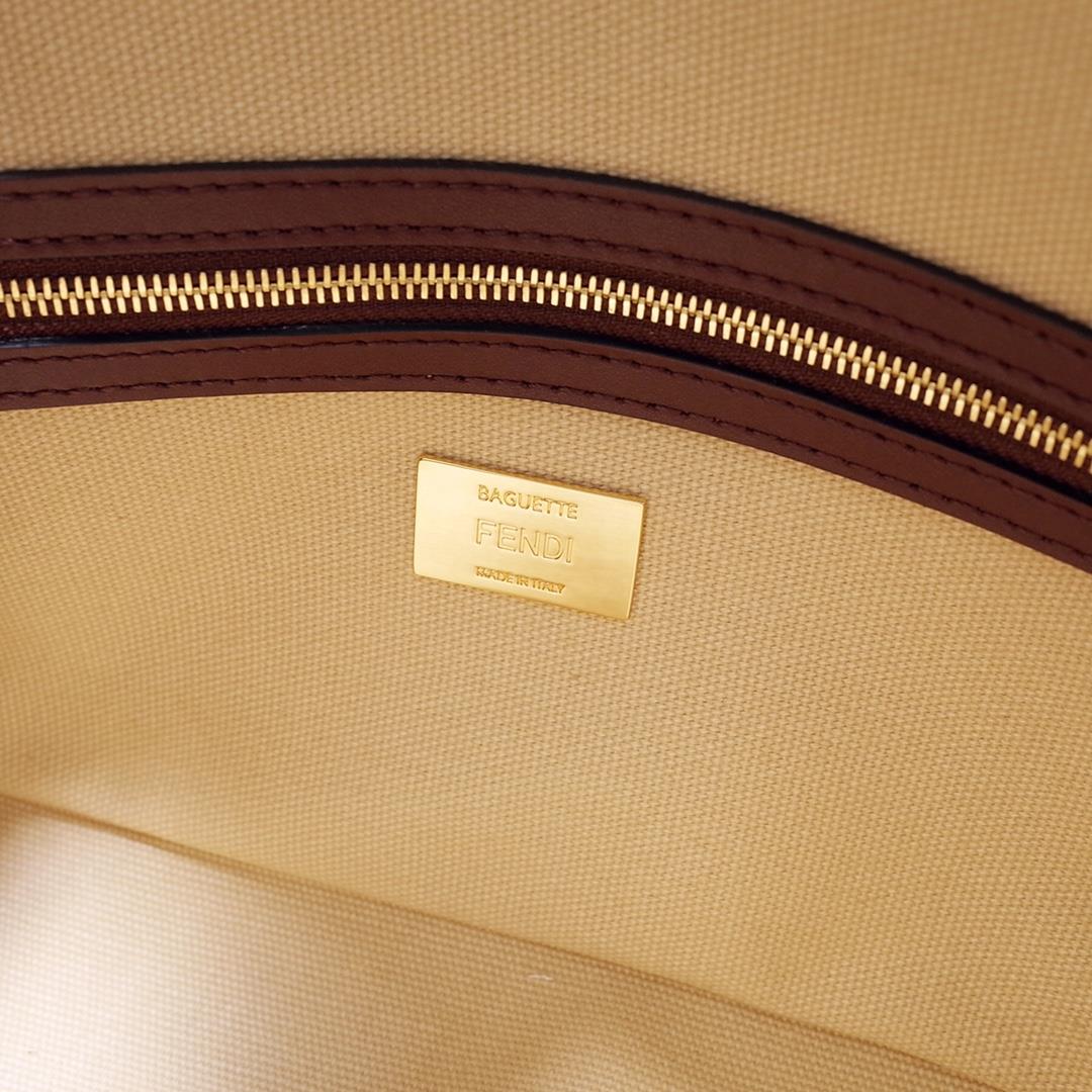 The FEND1 iconic Baguette handbag is made of beige canvas material adorned with FF pattern emb