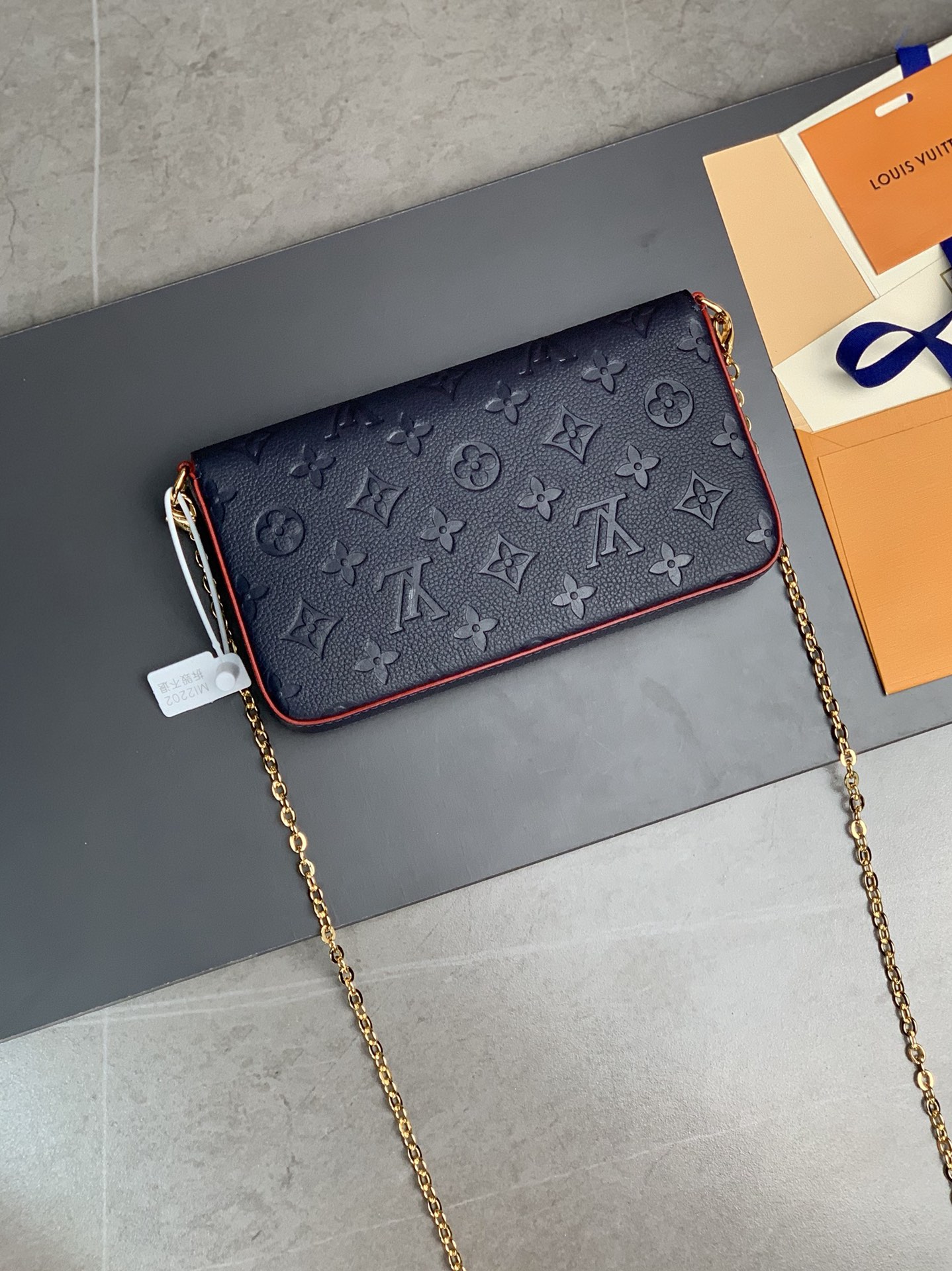 M64064 navy blue The Pochette F  licie Chain Bag is made of Monogram Imprente cowhide fabric a