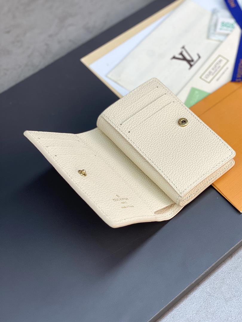 The M80151 milky white silk printed Cla wallet is made of Monogram Imprente soft grain cow