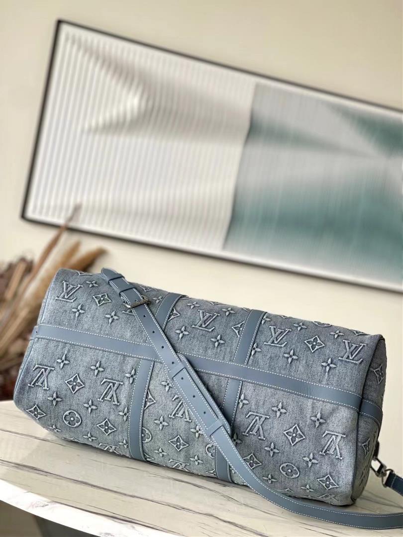 M22532 denim This Keepall Bandoulire 50 travel bag is embossed with Monogram pattern on fa