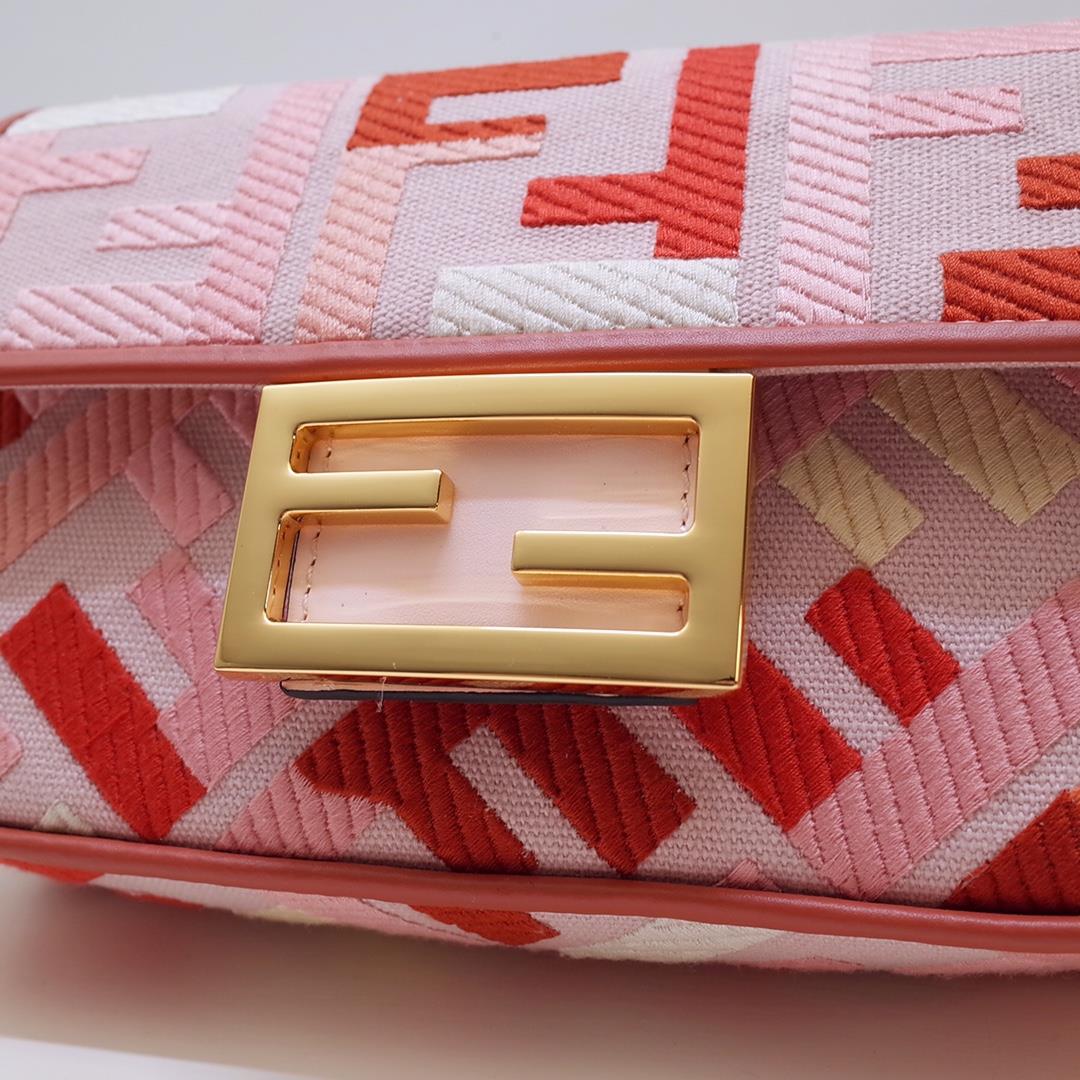 The FEND1 iconic Baguette handbag is made of canvas material and is adorned with red and pink 