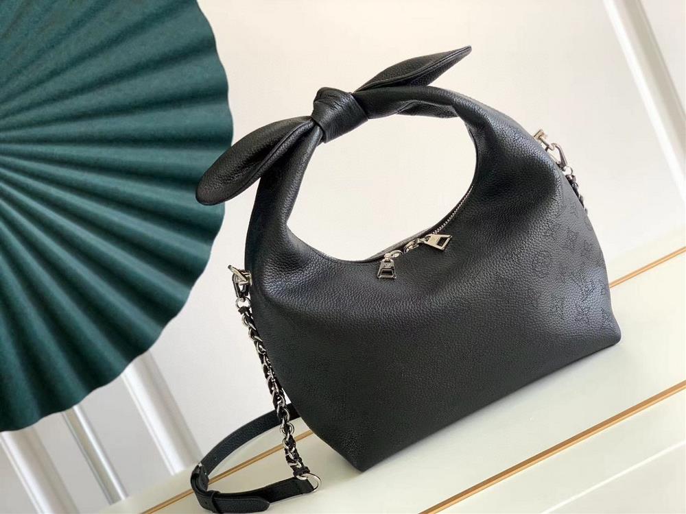 The M20700 M20703 Why Knot small handbag is made of iconic Monogram perforated cowhide leather combined with a knot shaped handle revealing a gentle