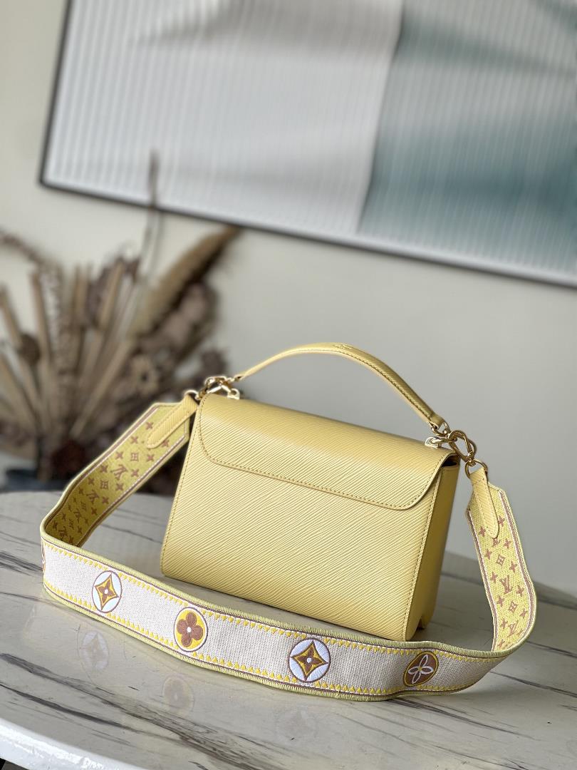 M22036 yellowThis Twist medium size handbag is paired with embroidered fabric shoulder straps 