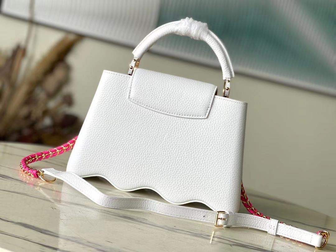 m22121 white waves bottom capushell small handbag is designed with new capucines at the bo